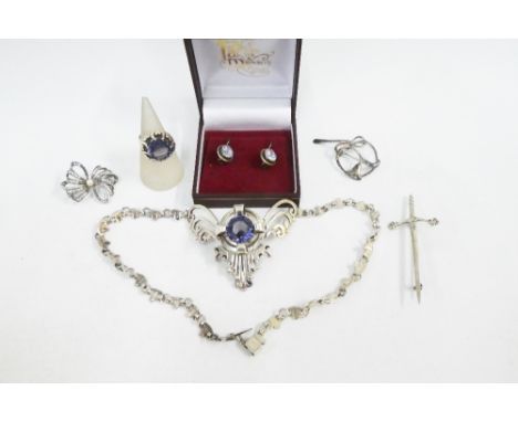 A collection of silver and white metal jewellery to include a necklace and matching ring, dagger kilt pin / brooch,  earrings