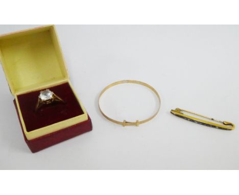 9ct gold ring, child's 9ct gold bangle and a yellow metal gemset bar brooch, (3) 