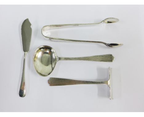 Silver items to include a pair of sugar tongs, pusher, butter knife and small ladle spoon (4) 