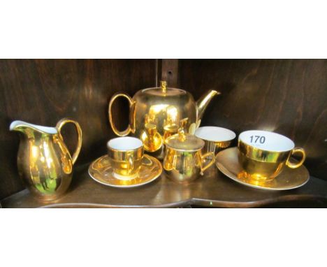 A Royal Worcester gold teapot and other gold coloured china