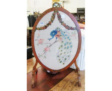 A painted satinwood oval firescreen with period embroidery