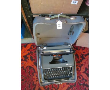 A vintage Olympia typewriter in grey case