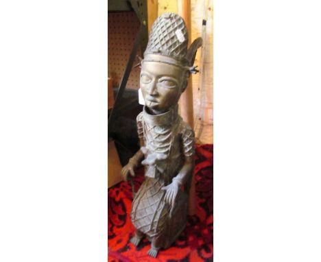 An Ashanti style brass figure with a walking stick