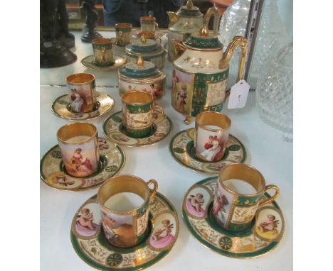 A Continental porcelain coffee set decorated ladies and cherubs with green, cream and gilt borders (some gilt rub)1 cup chipc