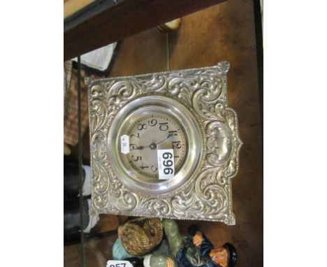 An embossed silver-plated desk clock