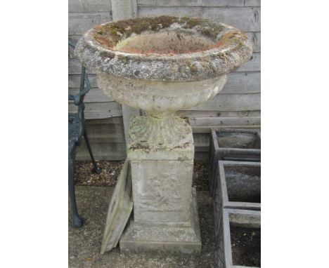 A concrete planter on base