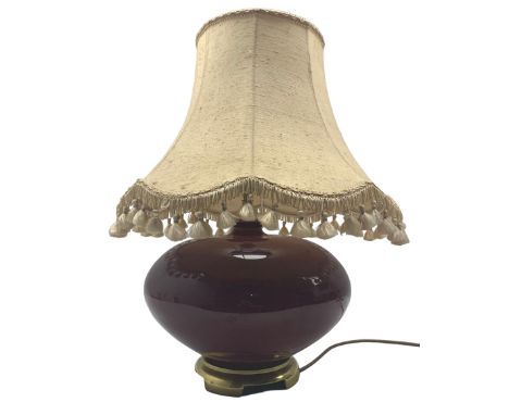 Ceramic lamp on metal foot in burgundy glaze together with tassle shade
