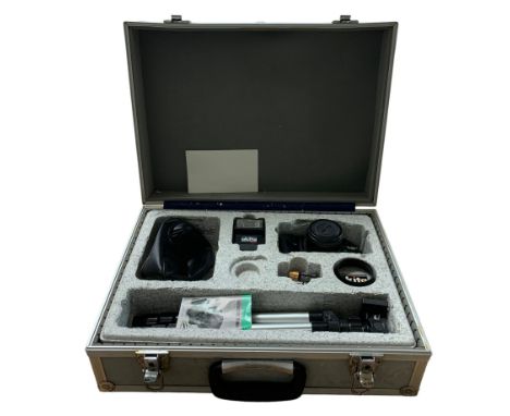 An Akita camera in fitted case with tripod and camera flash 