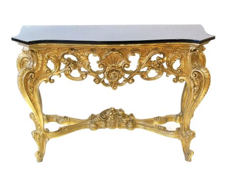 20th century console table of Rococo design, black granite serpentine top supported on gold painted gesso finish, base width 