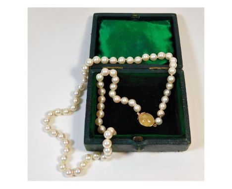 A cultured pearl necklace with Victorian 9ct rose gold clasp set with a possibly, cabochon cut yellow opal, 22in long 43.7g 