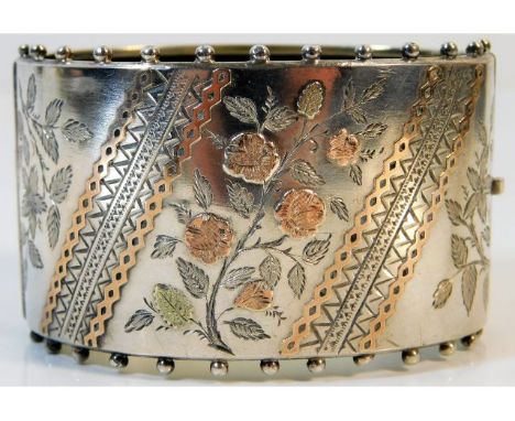 A 19thC. Birmingham silver bangle, date mark for 1883 with chased &amp; applied yellow &amp; rose coloured decor, maker R&amp