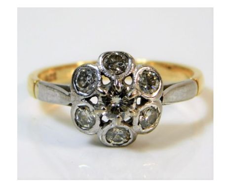 A two colour 18ct gold daisy style ring set with seven diamonds of 0.62ct diamonds 2.6g size L 