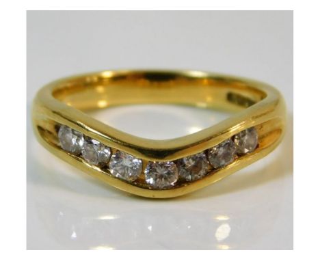An 18ct gold wishbone shaped ring set with seven diamonds of approx. 0.5ct 5.2g, size N 