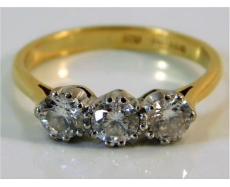 An 18ct gold trilogy ring set with approx. 1ct diamond size M/N 3g