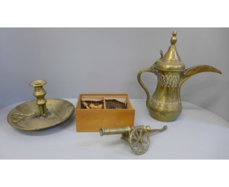 A boxed wooden chess set, a Persian brass tea pot, chamber stick and cannon, cannon a/f 