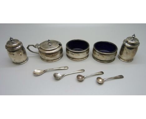 A five piece silver cruet set with three matching spoons and blue glass liners, Birmingham 1928, 165g, and a plated salt spoo