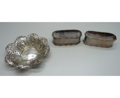 A pair of Celtic design silver napkin rings, Birmingham 1947, and a pierced silver dish, Chester 1897, 98g 