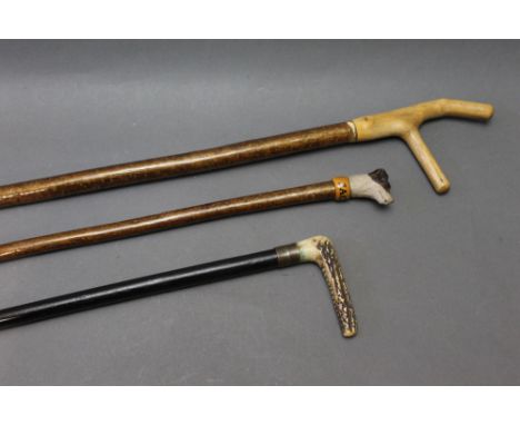 A hunting crop, together with a walking stick with dogs head handle, the collar marked Jack and another walking stick.  Lengt