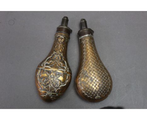 Two powder flasks, the first stamped Dixon and with star motif, length 20 cm, together with another, length 21 cm.