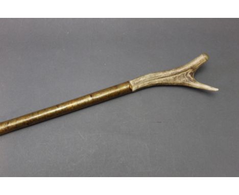 A hazel shafted walking stick with stag antler handle, capped with horn.  Length 128 cm.