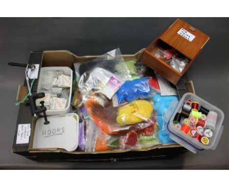 A box with fly tying flies, tools, various threads, hooks, feathers, furs etc.