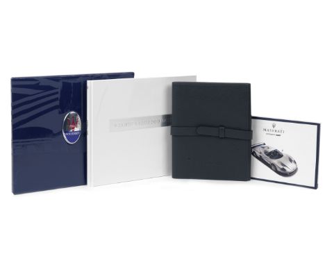 A Maserati MC12 Owner's Manual in leather wallet and prestige brochure,the manual in Italian, Spanish and German text, some l
