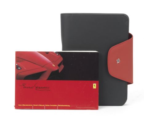 A Ferrari Enzo owner's manual in leather wallet,the Owner's Manual 3rd Edition dated May 2003, (small tear to spine), in Ital