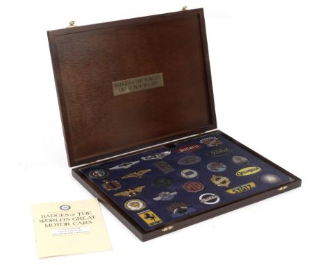 A cased set of 'Badges of the World's Great Motor Cars' by Danbury Mint,25 motor car silver-plated and gold-plated enamelled 