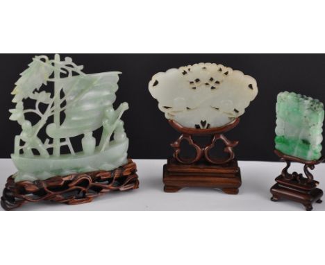 A carved jade group depicting a vessel at sea, H. 9cm, together with a similar figure modelled as a butterfly, and one other 