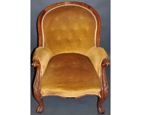 A Victorian walnut spoonback armchair upholstered in button gold draylon on carved cabriole legs