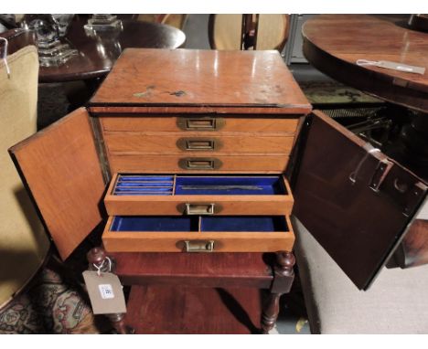 A late Victorian light oak jewellery casket fitted five silk lined compartmented drawers 