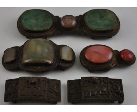 Two late 19th/ early 20th Century Chinese gilt metal hardstone and jade belt buckles together with a similar buckle part and 
