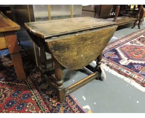 A 1920s 18th Century style oak drop leaf occasional table / joint stool, w:54cm