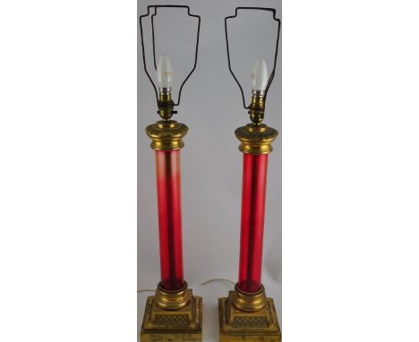 A pair of Victorian gilt brass and ruby glass column lamp bases on lattice cast square bases, H. 50 cm