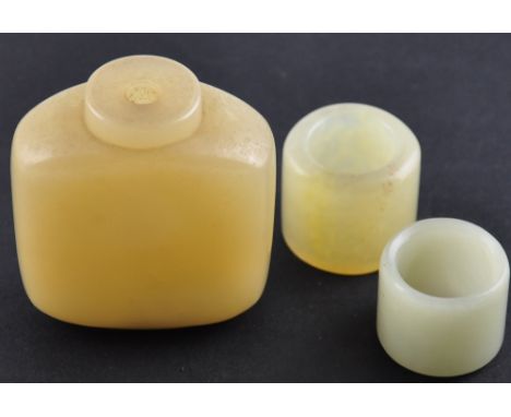 An early 20th Century Chinese pale jade scent bottle together with two similar thumb rings (bottle without stopper)