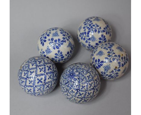 A Collection of Five Blue and White Ceramic Balls 