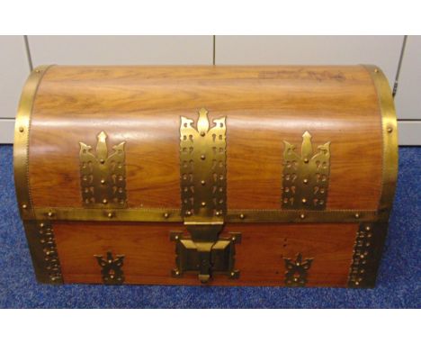 A rectangular Indian wooden trunk with brass mounts and hinged domed cover, 37 x 70 x 40cm