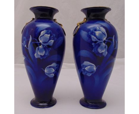 A pair of Royal Staffordshire Wilkinson Ltd baluster vases decorated with flowers against a blue ground, marks to the bases, 