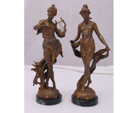 A pair of spelter Art Nouveau style figurines of ladies in classical attire on raised circular bases, 38cm (h)