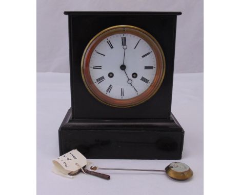 A Victorian slate mantle clock of rectangular form, the white enamel dial with Roman numerals, two train movement to include 