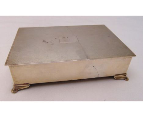 A hallmarked silver rectangular cigarette box engine turned cover, cedar wood lining on four bracket feet, Birmingham 1986