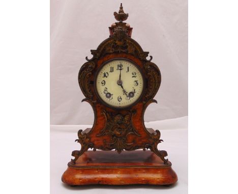 An early 20th century mantle clock, white enamel dial, Arabic numerals with applied scroll pierced brass mounts on shaped rec