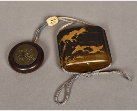 A Japanese black and gold lacquered four section inroWorked with cranes; together with a carved and pierced ivory ojime; and 