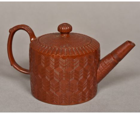 An 18th century English glazed engine turned Redware teapotWith acanthus capped scroll handle, the underside with pseudo Chin