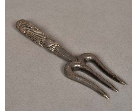 A Japanese silver trident forkThe handled worked with aquatic plants, signed.  17.5 cm long.    CONDITION REPORTS:  Generally