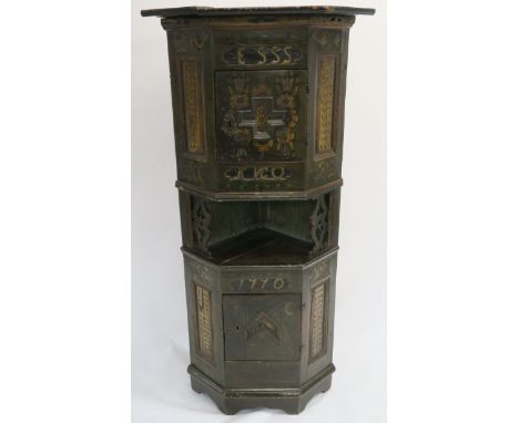 A CONTINENTAL PAINTED PINE CORNER CUPBOARD dated 1770 and named to ES and SS and other monograms, the moulded cornice above a