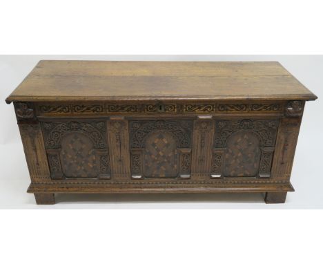 AN OAK AND MARQUETRY COFFER the hinged top above a band of inlaid scrolling foliage, flanked by portrait busts above three ca