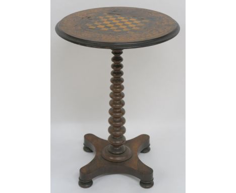A VICTORIAN INLAID  ROSEWOOD  CIRCULAR GAMES TABLE, with bobbin support on quadruple base, 76cm high x 54cm diameter Conditio