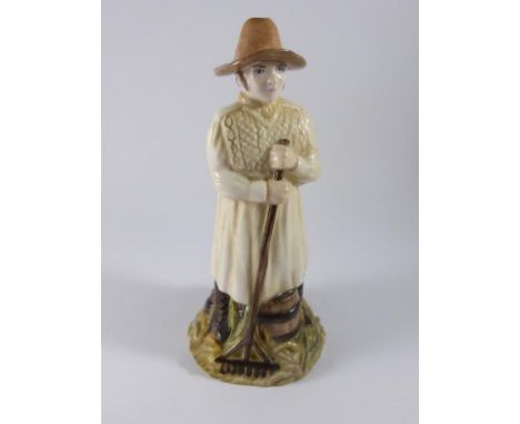 JAMES SKERRETT (EX ROYAL WORCESTER) PORCELAIN SNUFFER IN THE FORM OF A FARMER WITH RAKE, APPROX. 12 cm