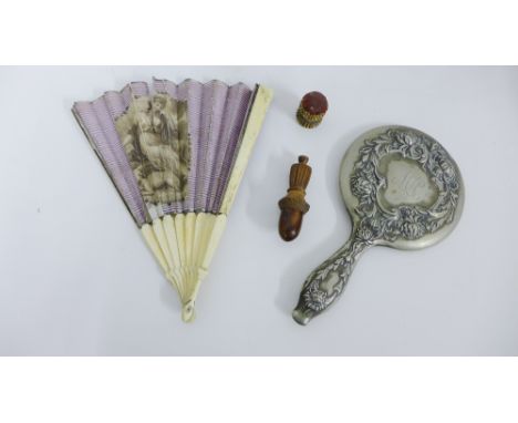 A mixed lot to include a treen pin cushion and treen needle container together with a pewter backed hand mirror and a fan wit
